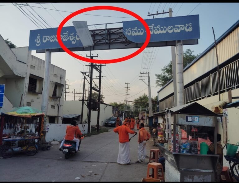 శ్రీ రాజరాజేశ్వర స్వామి దేవస్థానం వద్ద ప్రమాదకరంగా వేలాడుతున్న బోర్డు…..-పొంచి ఉన్న ప్రమాదం.. -పట్టించుకోని అధికారులు…